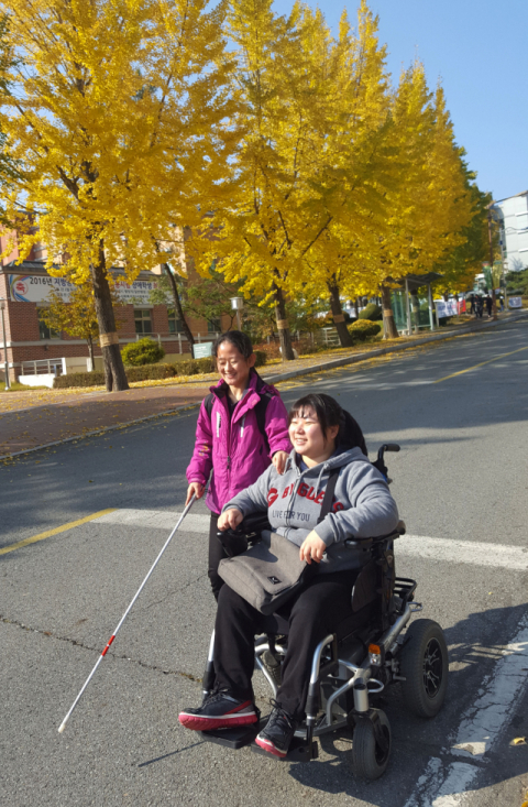 ▲ 지팡이를 짚은 김하은 학생(시각장애)과 휠체어를 탄 설진희 학생(오른쪽)이 함께 캠퍼스를 거닐고 있다.