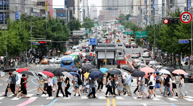 ▲ 전국에 비가 내리며 장마가 시작된 3일 오후 서울 마포구 홍대입구역 인근에서 시민들이 우산을 쓰고 길을 건너고 있다. 연합뉴스