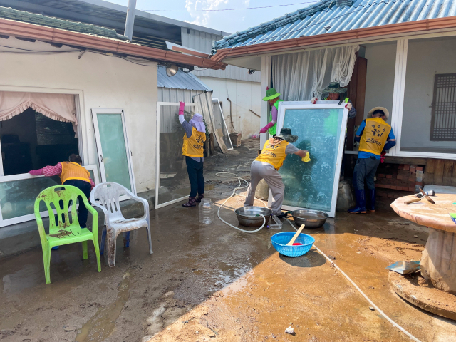 ▲ 자원봉사자들이 수해로 피해를 입은 가옥을 정리하고 있다.